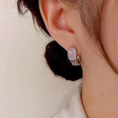 Model showcasing the dangle and style of the 14K Gold-Plated Exquisite Diamond Earrings