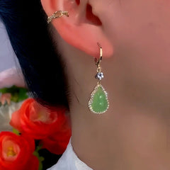Model showcasing the dangle and style of the 14K Gold-Plated Exquisite Green Gourd Earrings