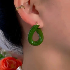 Model showcasing the dangle and style of the 14K Gold-Plated Exquisite Green Oil Drop Earrings