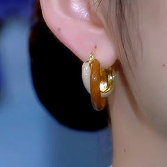 Close-up detail of the sparkling zircons and plating on the Contrast Color Winding Earrings