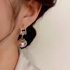 Close-up detail of the sparkling zircons and plating on the Pearl Heart Earrings