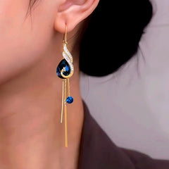 Model showcasing the dangle and style of the 14K Gold-Plated Exquisite Phoenix Crystal Threader Tassel Earrings