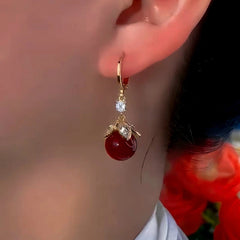 Close-up detail of the sparkling zircons and plating on the Red Bead Earrings