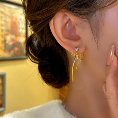 Close-up detail of the sparkling zircons and plating on the Bow Tassel Earrings