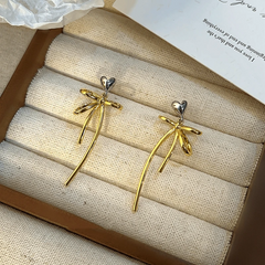 Angled view of the 14K Gold-Plated Exquisite Simple Heart-Design Bow Tassel Earrings