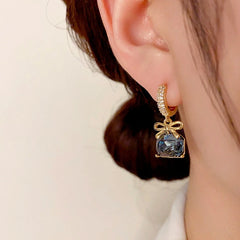 Close-up detail of the sparkling zircons and plating on the Diamond Bow Earrings