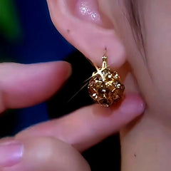 Model showcasing the dangle and style of the 14K Gold-Plated Exquisite Zircon Brown Diamond French Earrings