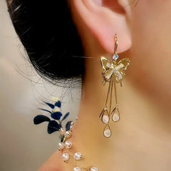 Model showcasing the dangle and style of the 14K Gold-Plated Exquisite Zircon Butterfly Crystal Ear Hook Tassel Earrings