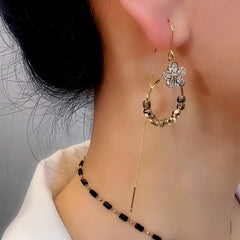 Model showcasing the dangle and style of the 14K Gold-Plated Exquisite Zircon Flower threader Tassel Earrings