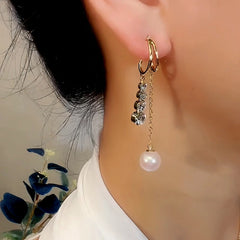 Model showcasing the dangle and style of the 14K Gold-Plated Exquisite Zircon Pearl Earrings