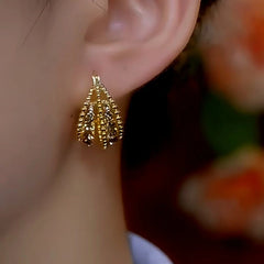 Close-up detail of the sparkling zircons and plating on the Firework Tassel Earrings