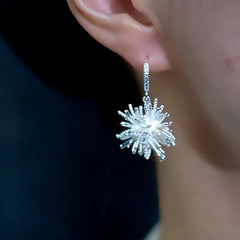 Model showcasing the dangle and style of the 14K Gold-Plated Fireworks Earrings