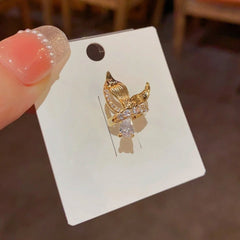 Model showcasing the dangle and style of the 14K Gold-Plated Fishtail Ear Bone Clips ( 1 Pair )