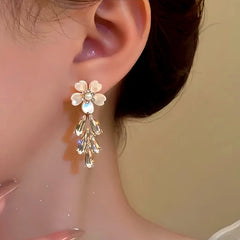 Model showcasing the dangle and style of the 14K Gold-Plated Flower Diamond Tassel Earrings
