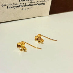 Angled view of the 14K Gold-Plated Flower Ear Hook Earrings