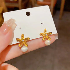 Close-up detail of the sparkling zircons and plating on the Hanging Pearl Earrings