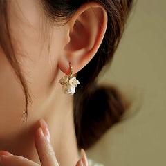 Model showcasing the dangle and style of the 14K Gold-Plated Flower Pearl Earrings