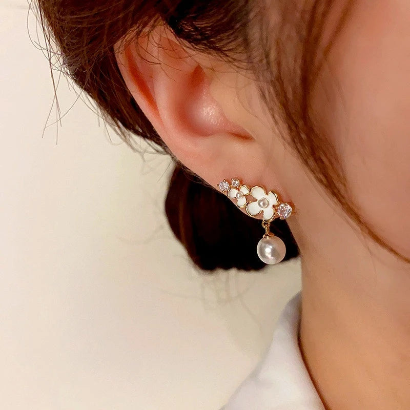 Close-up detail of the sparkling zircons and plating on the Flower Pearl Drop Earrings