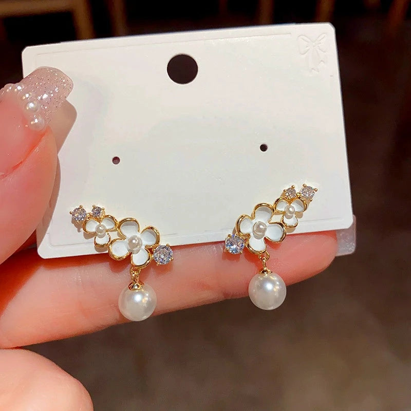 Angled view of the 14K Gold-Plated Flower Pearl Earrings