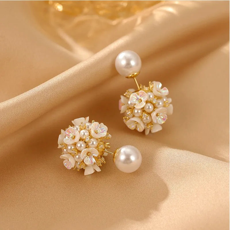 Angled view of the 14K Gold-Plated Flower Pearl Jacket Earrings