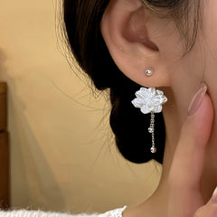 Model showcasing the dangle and style of the 14K Gold-Plated Flower Screw Jacket Earrings