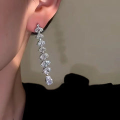 Model showcasing the dangle and style of the 14K Gold-Plated Flower Water Drop Earrings