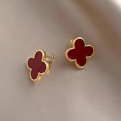 Model showcasing the dangle and style of the 14K Gold-Plated Four-Leaf Clover Stud Earrings