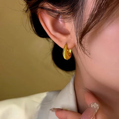 Close-up detail of the sparkling zircons and plating on the Twisted Hoop Earrings