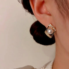 Close-up detail of the sparkling zircons and plating on the Geometric Pearl Studs