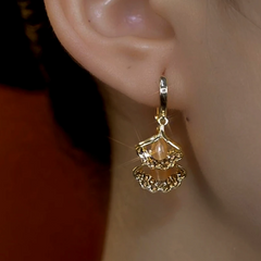 Model showcasing the dangle and style of the 14K Gold-Plated Ginkgo Leaf Tassel Earrings