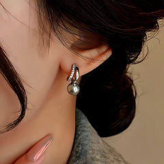 Model showcasing the dangle and style of the 14K Gold-Plated Gray Pearl Earrings