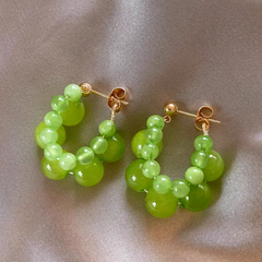 Angled view of the 14K Gold-Plated Green Bead Earrings
