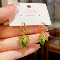 Angled view of the 14K Gold-Plated Green Double-Layer Maple Leaf Earrings