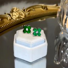 Angled view of the 14K Gold-Plated Green Four-Leaf Stud Earrings