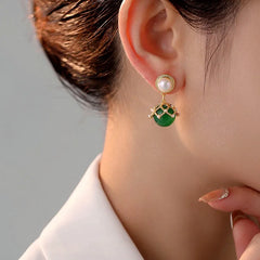 Model showcasing the dangle and style of the 14K Gold-Plated Green Pearl Earrings