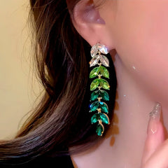 Model showcasing the dangle and style of the 14K Gold-Plated Green Wheat Tassel Earrings