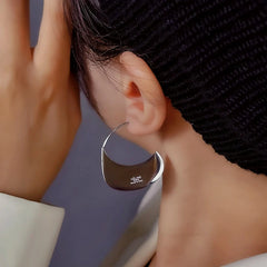 Close-up detail of the sparkling zircons and plating on the Handbag Threader Earrings