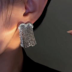 Angled view of the 14K Gold-Plated Heart Tassel Earrings