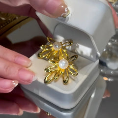 Close-up detail of the sparkling zircons and plating on the Flower Pearl Studs