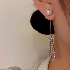 Angled view of the 14K Gold-Plated Hollow Pearl Diamond Tassel Earrings