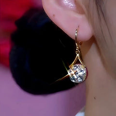 Model showcasing the dangle and style of the 14K Gold-Plated Hot Style Zircon Water Drop Earrings