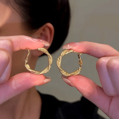 Close-up detail of the sparkling zircons and plating on the Twisted Hoop Earrings