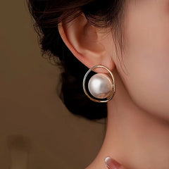 Model showcasing the dangle and style of the 14K Gold-Plated Large Pearl Earrings