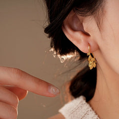 Model showcasing the dangle and style of the 14K Gold-Plated Leaf Ear Hooks