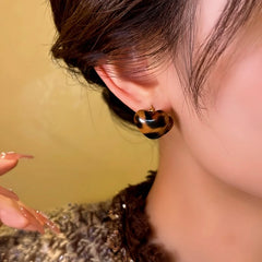 Close-up detail of the sparkling zircons and plating on the Leopard Heart Earrings