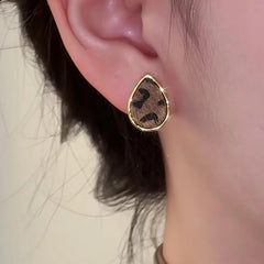 Model showcasing the dangle and style of the 14K Gold-Plated Leopard Print Water Drop Stud Earrings