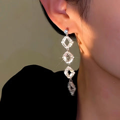 Model showcasing the dangle and style of the 14K Gold-Plated Long Crystal Tassel Earrings