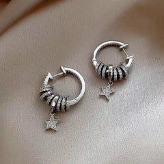 Model showcasing the dangle and style of the 14K Gold-Plated Lucky Star Zircon Earrings