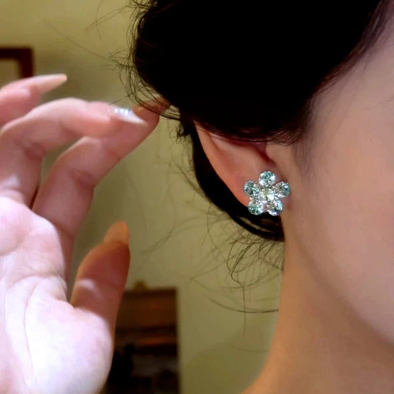 Close-up detail of the sparkling zircons and plating on the Blue Flower Studs