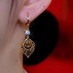 Model showcasing the dangle and style of the 14K Gold-Plated Luxury Brown Diamond Rest Of My Life With You Earrings
